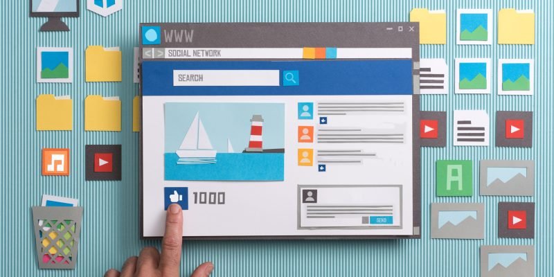 Social media post with comments in a browser window, a user is pressing the like button: social networks and community concept, collage and paper cut composition