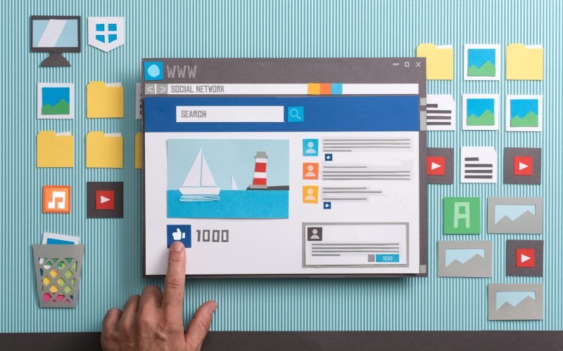 Social media post with comments in a browser window, a user is pressing the like button: social networks and community concept, collage and paper cut composition