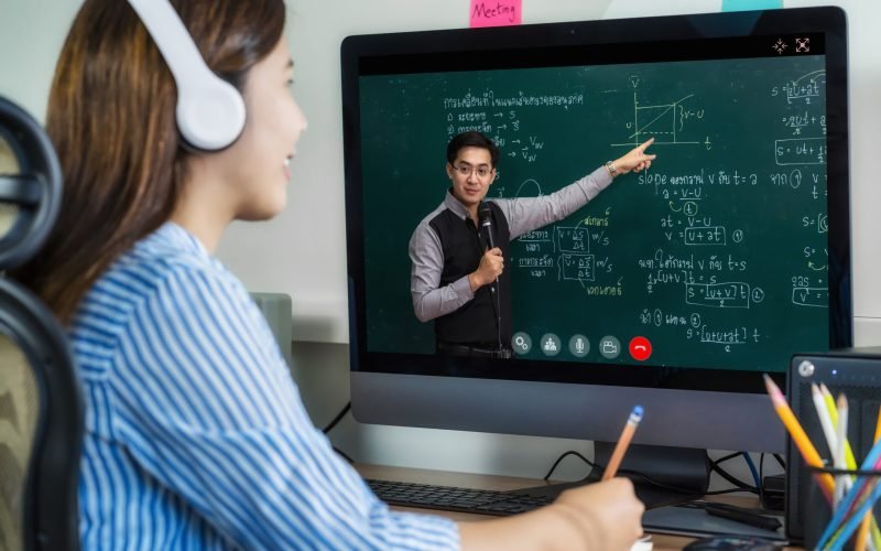 Rear View of Asian student learning with teacher over the physics formular in thai laguage