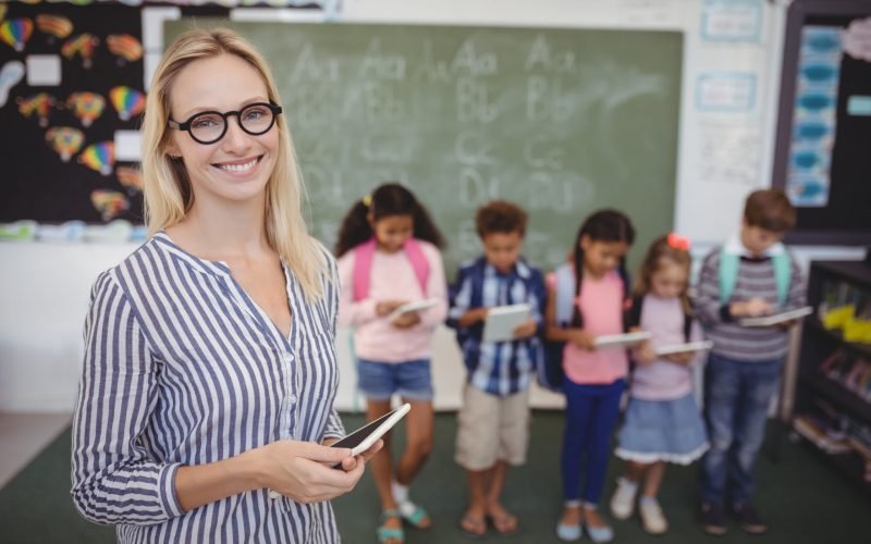 teacher-helping-students-learn-with-tablets-in-cla-2026-01-11-10-31-13-utc